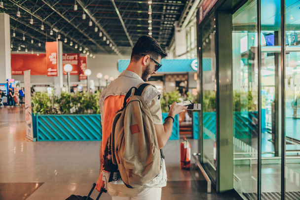 Passager masculin avec passeport européen au terminal de départ, à l'intérieur
 - Photo, image