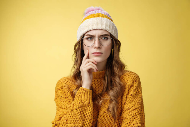 Serious-looking complicated attractive smart girl solving issue mind look disturbed perplexed aside touching face frowning thoughtful, doubting suspicious feeling, standing unsure yellow background - Photo, Image