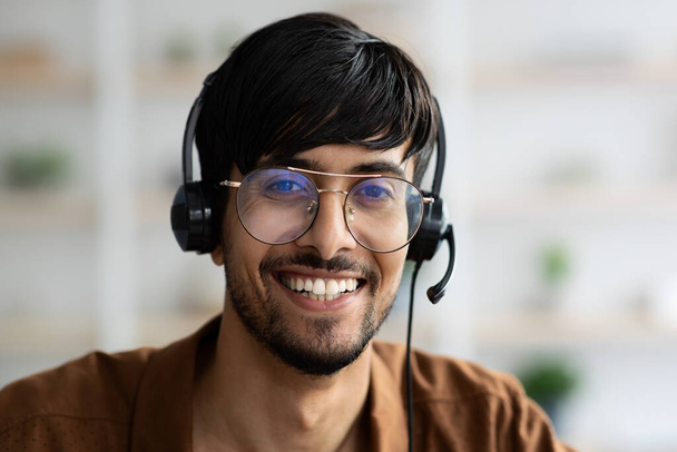 Closeup portrait of happy indian man using headset - Foto, immagini