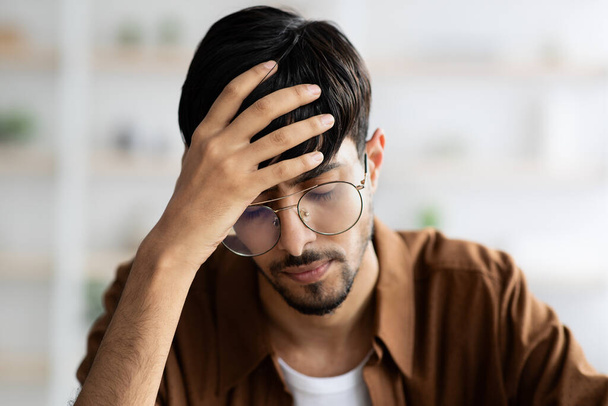 Stressed middle eastern man employee suffering from headache - Photo, Image