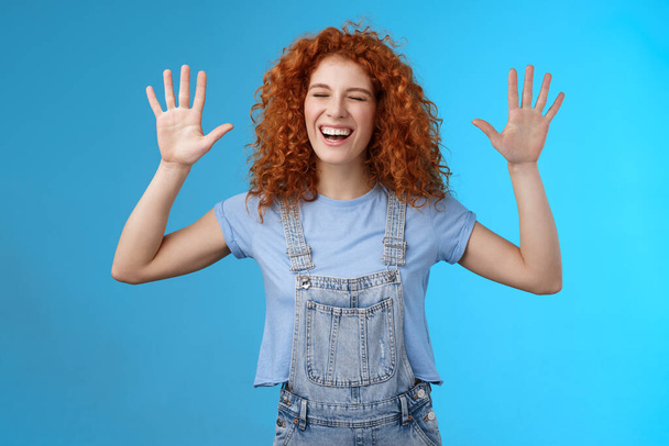 Fine you won. Cheerful carefree playful attractive redhead curly girlfriend having fun laughing out loud joyful raise hands up surrender fool around enjoy cool awesome time spending friend - Photo, Image