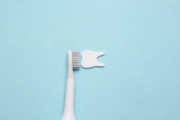 Tandheelkundige zorg concept. Tandenborstel tanden op blauwe achtergrond. Bovenaanzicht. Vlakke plaat - Foto, afbeelding