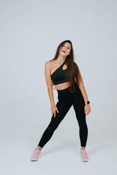 Sporty fit beautiful young woman in sportswear bra and black pants - Foto, Imagem