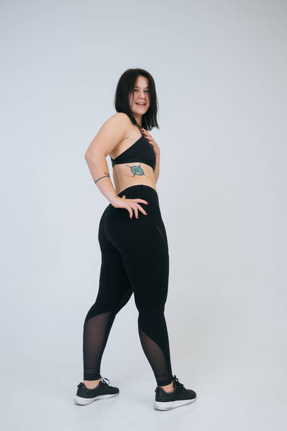 Young overweight woman on a white background. Bodypositive concept. - Photo, Image