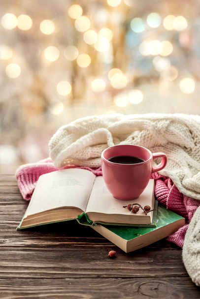 Morning coffee. Cozy composition: a cup of coffee on a wooden table and a warm sweater, an open book. Still life concept. Copy space - Fotografie, Obrázek