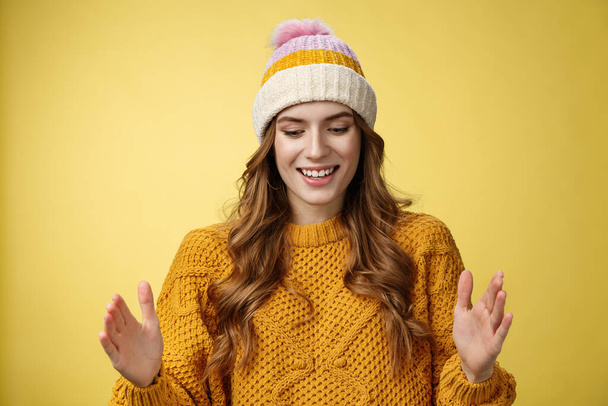 Attractive tender girl retelling friends what got b-day present describing large present box smiling happily look down shaping big thing talking joyfully excited, standing happy yellow background - Foto, Imagen