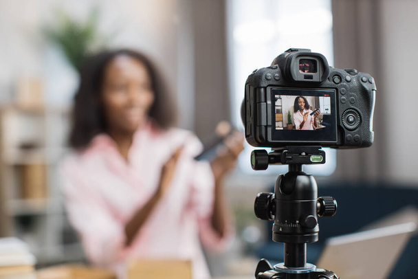 Woman recording video blog while unboxing new smartphone - Valokuva, kuva