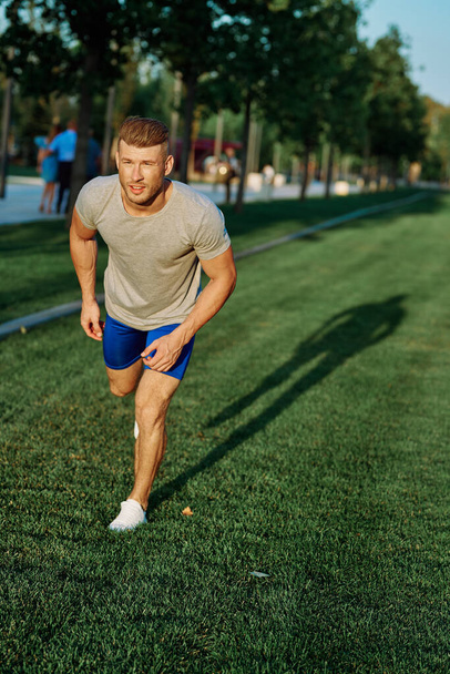 athletic man in the park workout jogging exercise summer - Fotografie, Obrázek