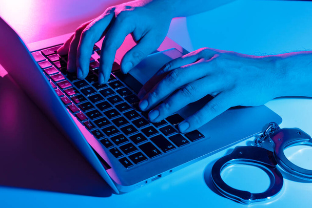 Cyber crime concept with man in handcuffs. Phishing attack, malware - Valokuva, kuva