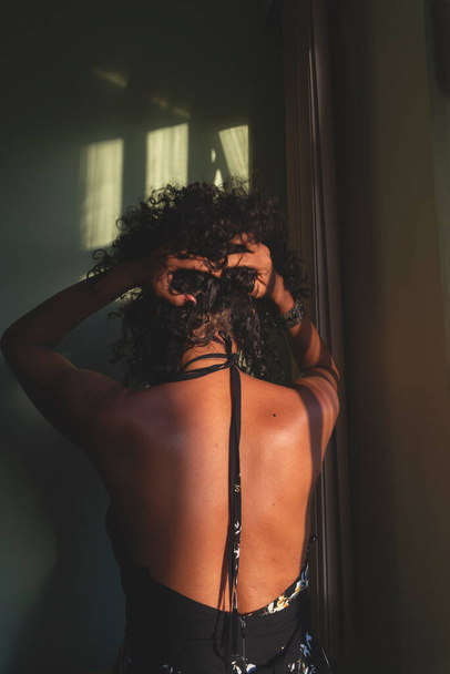 Portrait of a woman against light and shadow background. Salvador, Bahia, Brazil. - Foto, imagen