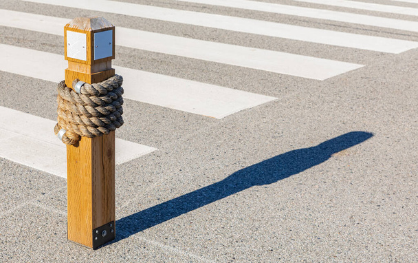 Zebra Crossing, Low Angle View, wooden bollard with traffic zebra. Street view, selective focus, nobody, copy space for text - Photo, Image