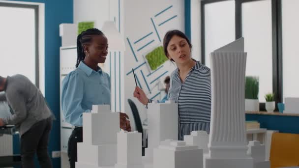 Architects giving highfive and celebrating urban project progress with building model - Footage, Video