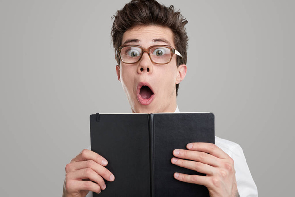 Shocked funny student with book - Фото, изображение