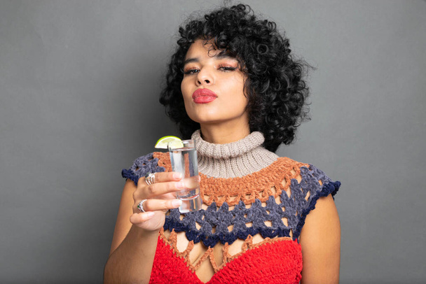 beautiful Mexican woman toasting with shot of silver tequila - Foto, Imagem