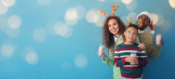 African-American family with Christmas decor and tasty hot chocolate on color background with space for text - Fotografie, Obrázek