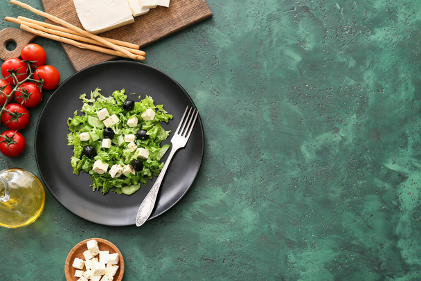 Plate with fresh Greek salad on green background - Zdjęcie, obraz