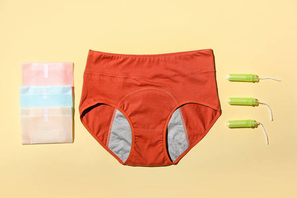 Period panties, pads and tampons on color background - Φωτογραφία, εικόνα