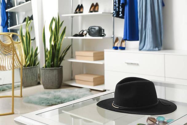 Trendy felt hat on table in boutique - Photo, Image