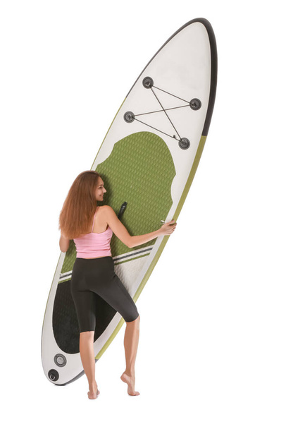 Sportowa młoda kobieta z wyżywieniem dla supsurfingu na białym tle - Zdjęcie, obraz