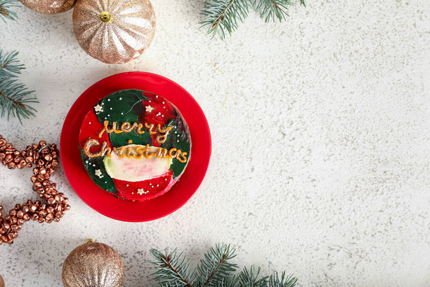 Plate with tasty bento cake and Christmas decor on white background - Φωτογραφία, εικόνα