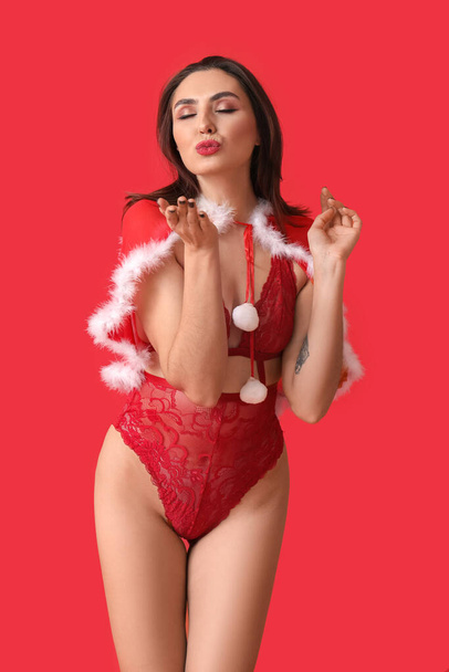 Sexy young woman in Santa costume and lingerie on color background - Fotoğraf, Görsel