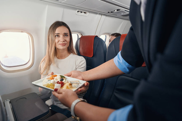 Thankful female getting her breakfast on airplane - Fotoğraf, Görsel