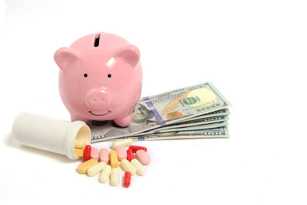 Pills, piggy bank and lot money on white background, concept expensive medicine and medicines - Foto, Imagen