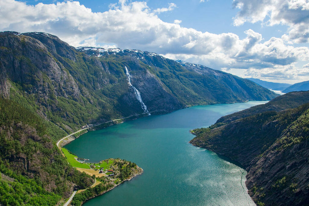 A landscape of the Langfoss waterfall and mountains in Akrafjorden, Norway - 写真・画像