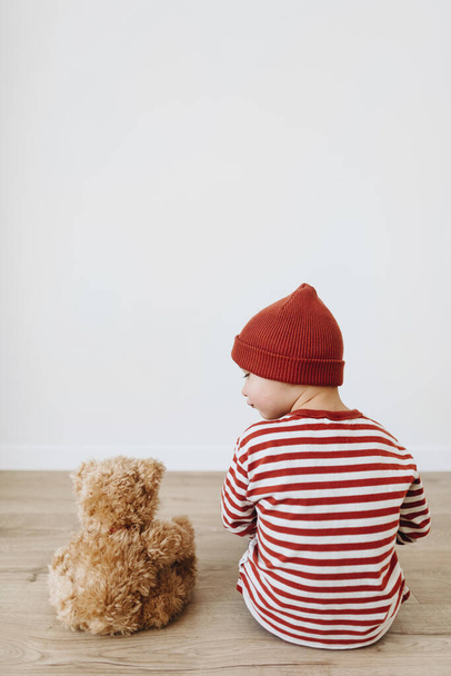 Portrait of little boy playing with his friend teddy bear toy - Fotó, kép