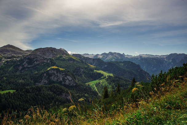A beautiful shot of greenery-covered hills and mountain range in Berchtesgaden, Germany - Fotó, kép