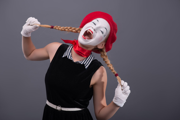 Portrait of female mime with white funny face - 写真・画像