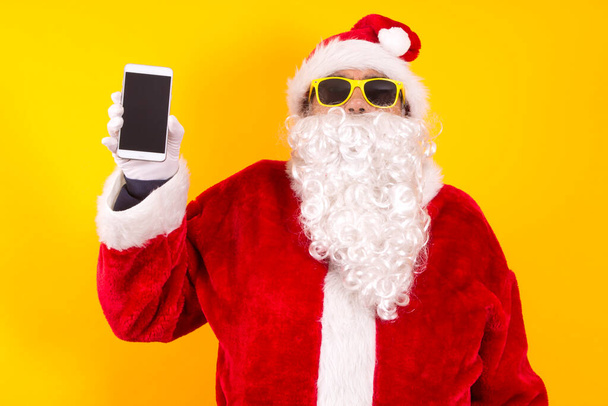 santa claus showing mobile phone isolated - Fotoğraf, Görsel