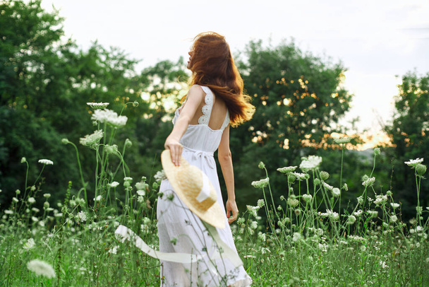 pretty woman in a field in nature white dress fresh air - 写真・画像