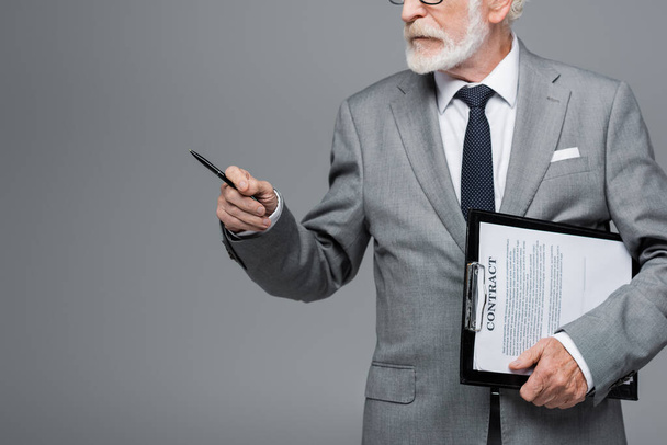 cropped view of senior businessman with contract pointing with pen isolated on grey - Фото, зображення