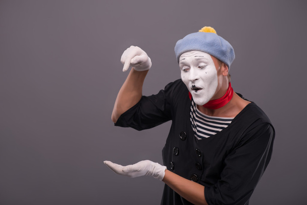 Portrait of young mime boy showing something with his hands - Fotó, kép
