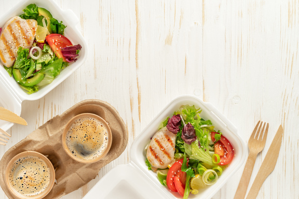 Cajas de almuerzo y café sobre fondo de madera blanca. Entrega de comida, vista superior, espacio para copiar. - Foto, Imagen