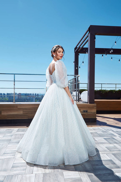 Beautiful woman bride fashion model brunette hair bright makeup pretty wear long silk white dress with lace bridal ceremony wedding espousal in blooming romance garden party marriage happy big day. - Zdjęcie, obraz