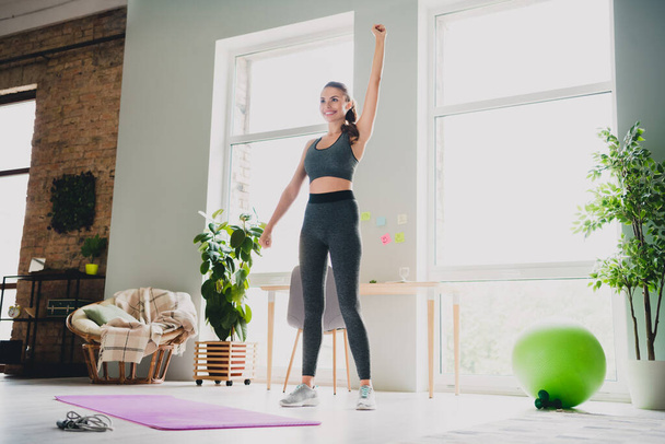 Full length body size view of attractive cheerful strong sportive girl doing physical activity developing muscles at light home indoors - Foto, afbeelding