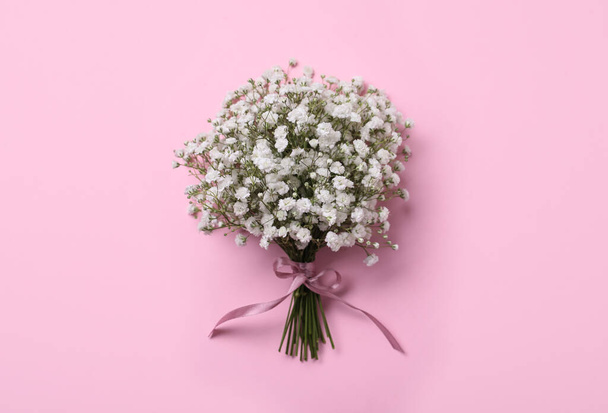 Bouquet of white gypsophila with ribbon on pink background, top view - Φωτογραφία, εικόνα