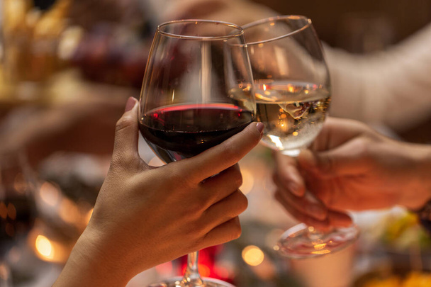 close up of hands toasting wine at christmas party - 写真・画像