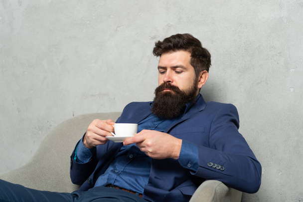 One more relaxing cup of tea. Manager man drink coffee relaxing in armchair. Rest break at work - Foto, Imagen