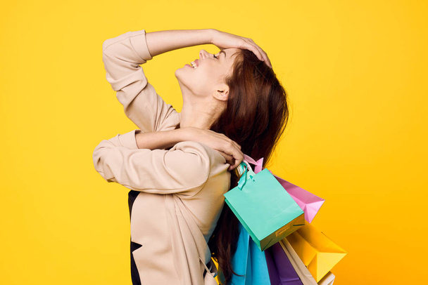 smiling woman with packages in hands Shopaholic isolated background - Fotoğraf, Görsel