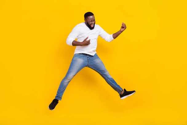 Full size portrait of active excited man hands playing imagine guitar have fun rejoice isolated on yellow color background - Fotoğraf, Görsel