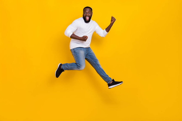 Full length photo of overjoyed person raise fists triumph luck shout yes isolated on yellow color background - Photo, Image
