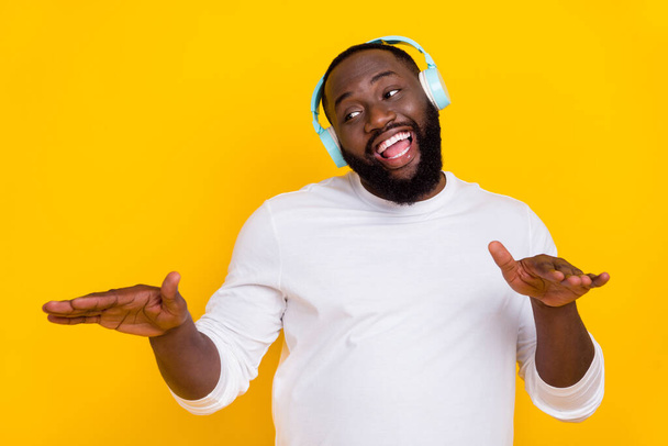 Portrait of carefree positive guy enjoy excited melody sound have fun isolated on yellow color background - Фото, изображение