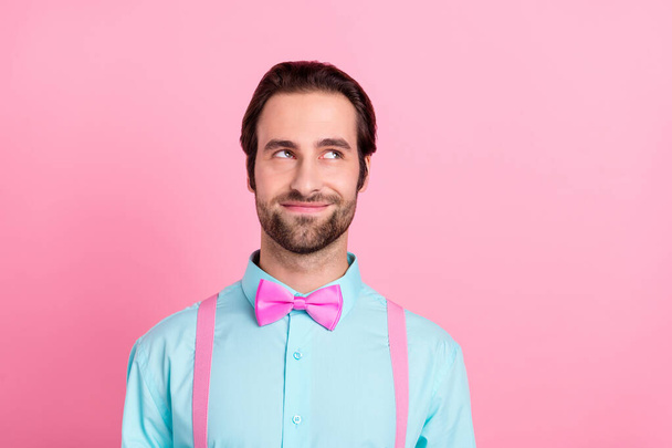 Photo of dreamy cute young man wear turquoise outfit smiling looking empty space isolated pink color background - Fotografie, Obrázek