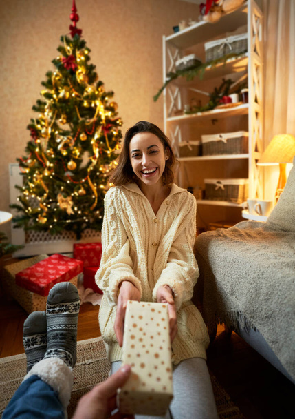 First person view of woman getting present box, enjoying Christmas and New Year time - Foto, immagini