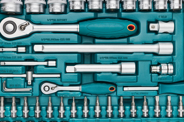 Ratchet with many attachments in plastic case. Work tools. Universal tool set. Background - Фото, зображення