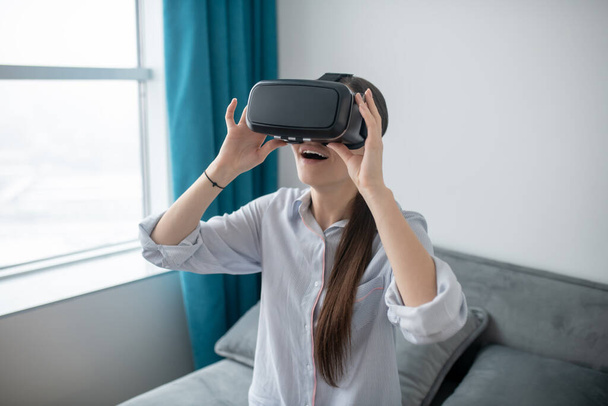Female in VR glasses enjoying virtual reality - Foto, Imagem