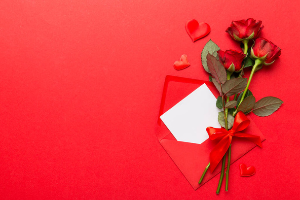 Valentine day composition with Envelope, rose flower and Red heart on table. Top view, flat lay. Holiday concept. - Zdjęcie, obraz